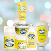 Image of various Boy Butter Original Lubricant with Coconut Oil products, including tubes, tubs, and pump bottles in their signature yellow packaging. Expertly crafted as an oil-based lubricant by Boy Butter, they guarantee a non-staining experience. The display is set against a blurred background with vibrant bokeh lights.